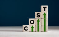 Cost increase and inflation concept. The word cost on wooden cubes with arrows going up.